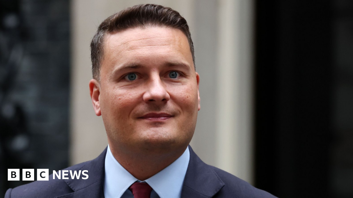 Health Secretary Wes Streeting stands outside 10 Downing Street, wearing a blue shirt and a navy suit 