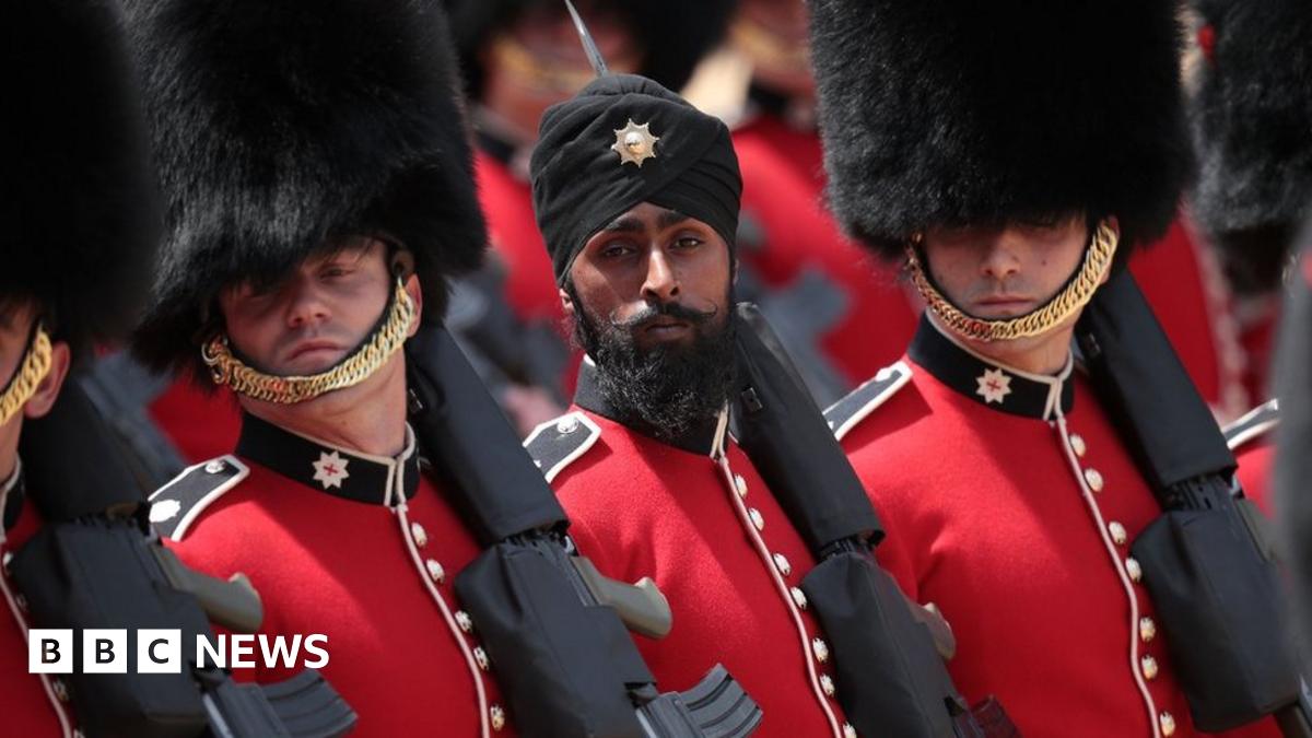 Coldstream Guards soldier Charanpreet Singh Lall marches during Trooping The Colour parade on 9 June