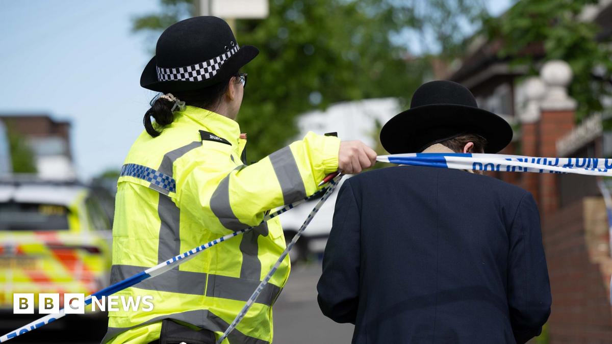 Police lifting a cordon to allow a person in