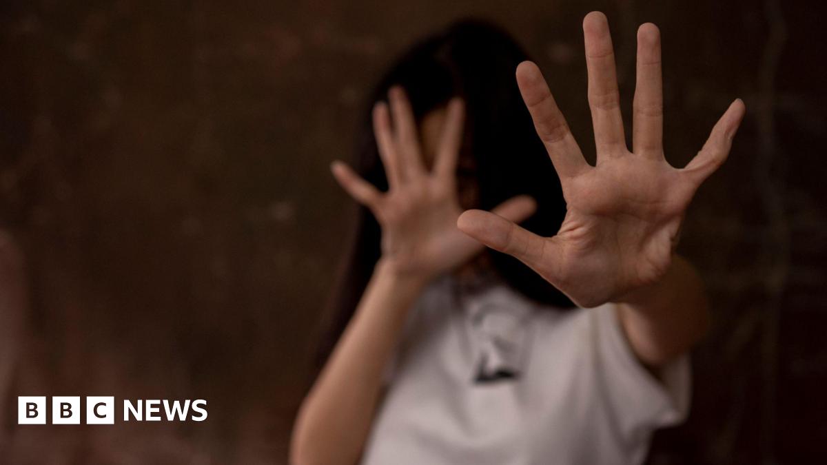 Women puts her hands up to shield herself - stock photo from Getty