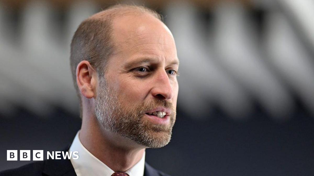 A close-up of Prince William, during a visit to Wales in December 2025. He is wearing a suit with a red tie. 
