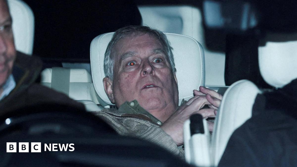 Andrew Mountbatten-Windsor slumped in the back seat of a car 