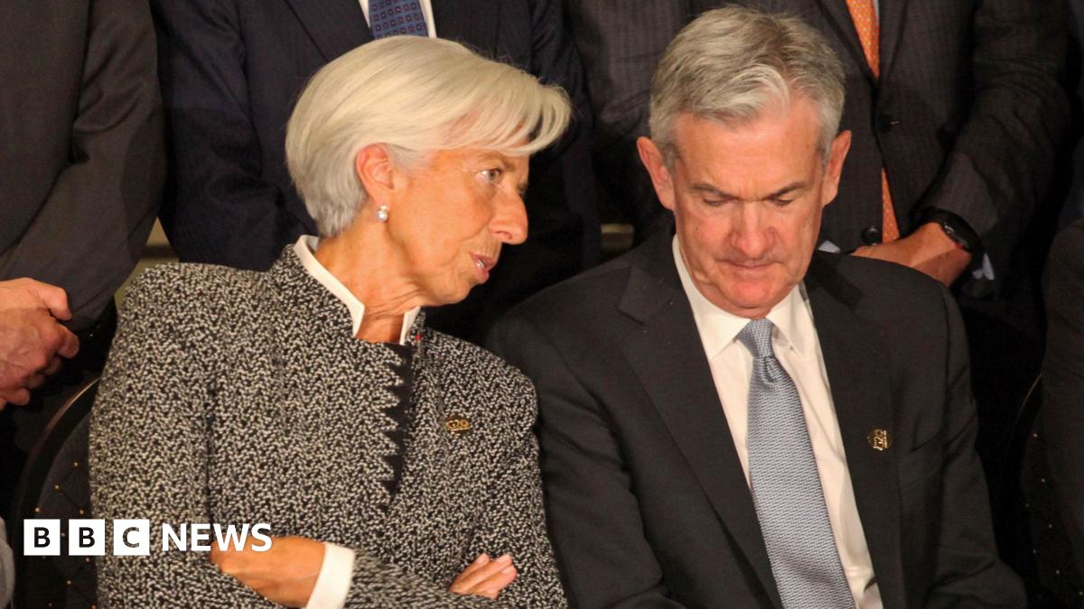 Christine Lagarde, Director of the International Monetary Fund, and Jerome Powell, President of the Federal Reserve, sit together for a group photo at the meeting of G20 finance ministers in July 2018