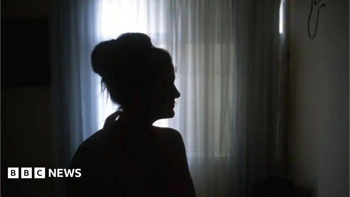 A silhouette of a woman. She cannot be identified. 