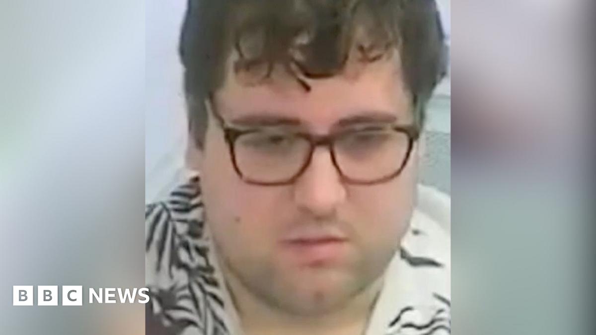 Close up of Bennett's face, he is wearing glasses and has brown hair. He is also wearing a t-shirt with plant patterns on.