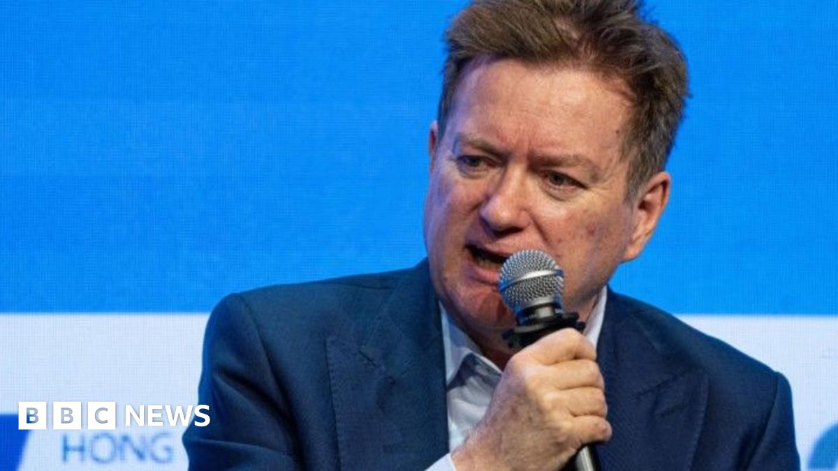 Paul Marshall wearing a blue suit, seated and holding a microphone at the Hong Kong Global Financial Leaders Investment Summit in October 2023
