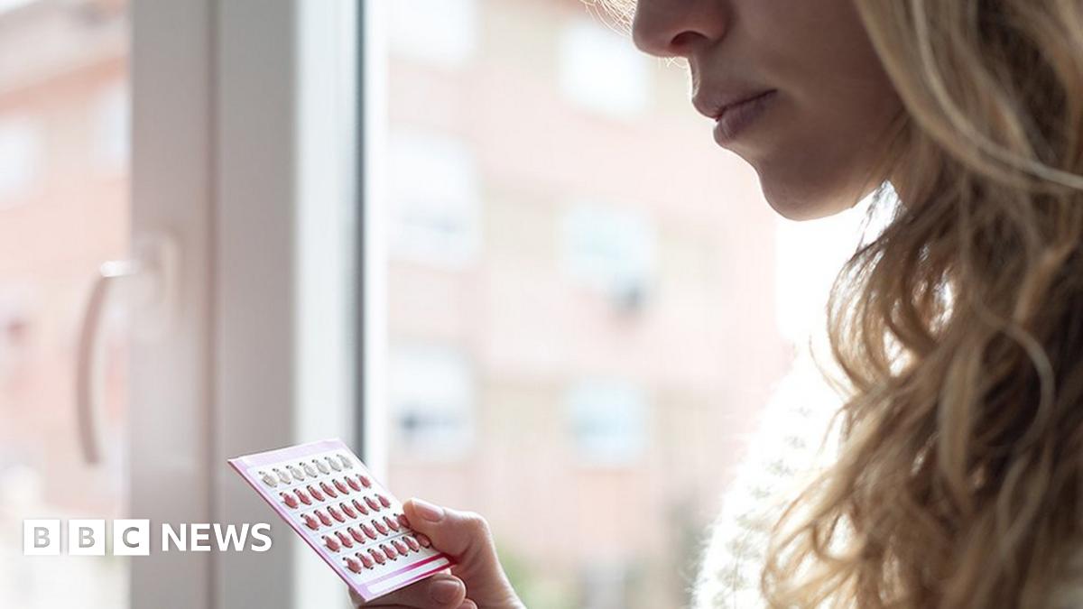 Woman holding contraceptive pills