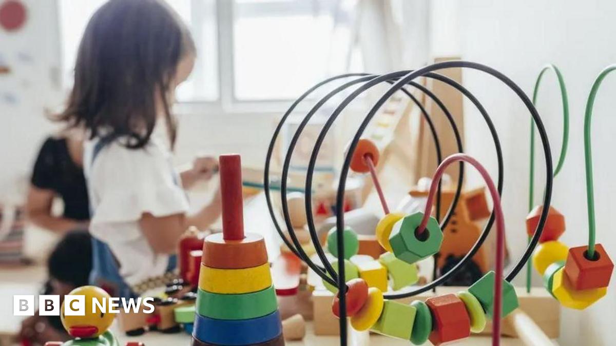 Child playing in a nursery with toys in foreground