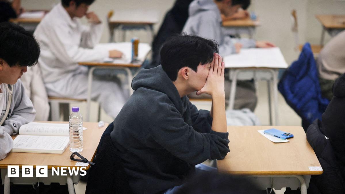 Students wait for the start of the annual college entrance examinations, also known as Suneung, at an exam hall in Seoul
