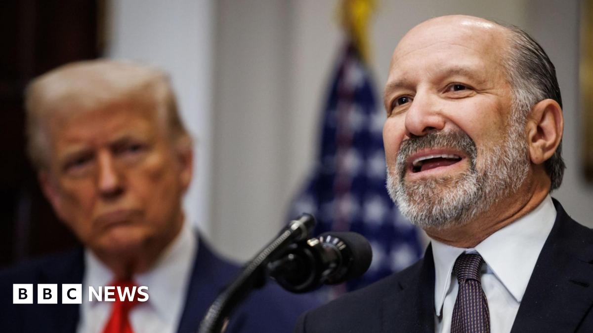 US Commerce Secretary Howard Lutnick wears dark suit, patterned tie and white shirt as he speaks at the White House, on 3 March 2025. President Donald Trump is standing to Lutnick's right. 