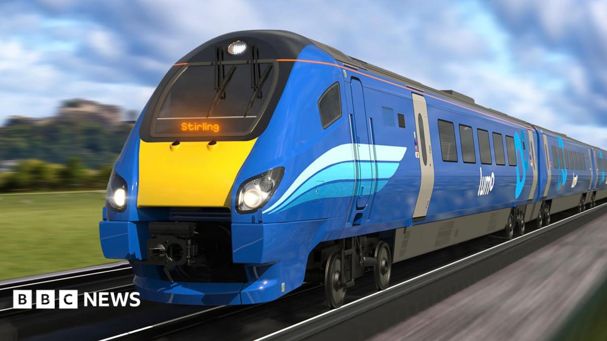 A blue and yellow Stirling train traveling on tracks.