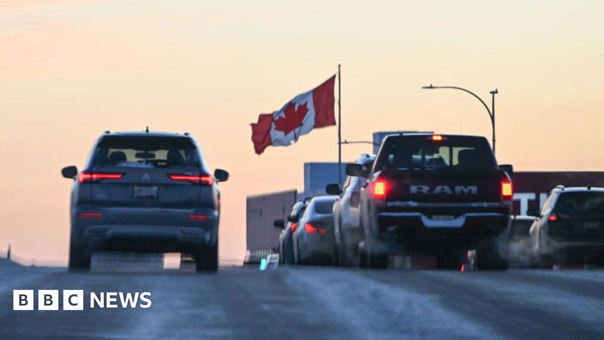 Cars on a highway with a Canadian flag