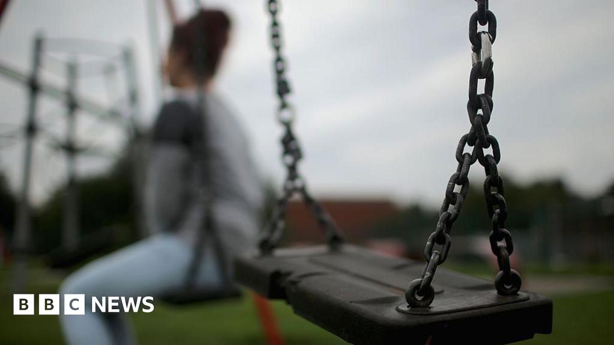 A stock image of a girl sat on a swing. The girl's identity has been blurred.