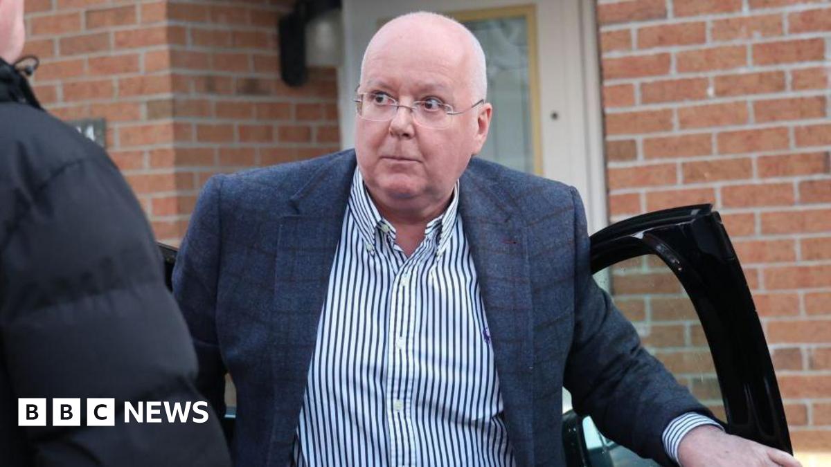 Peter Murrell climbing out of a car