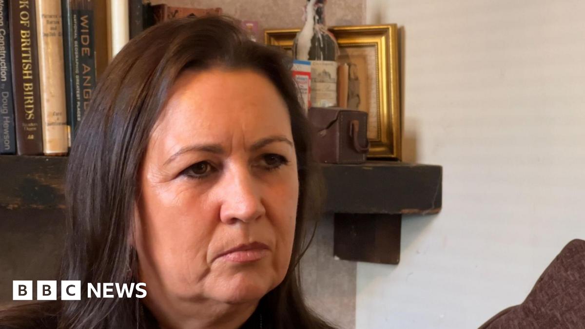 Beth Hewson sat in front of a bookcase