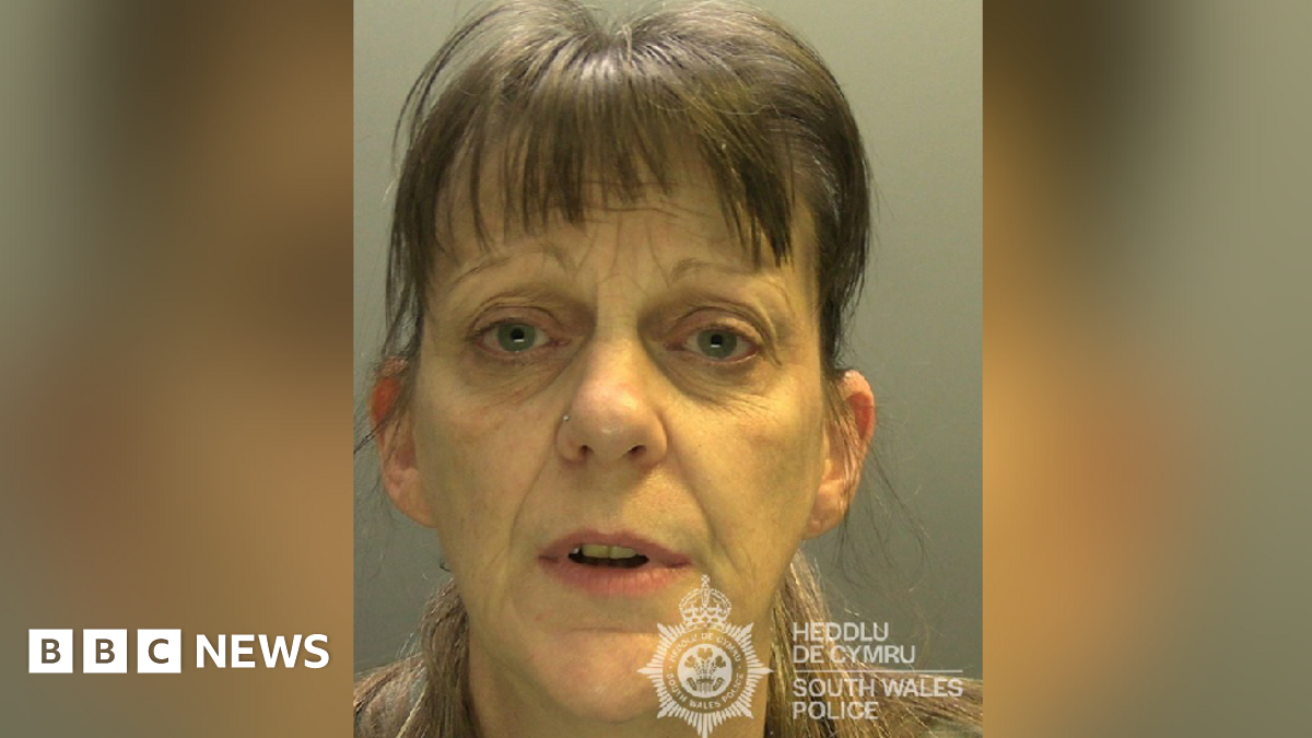 Custody photograph of Tracy Turner, 52. She has brown hair pulled back in a ponytail, with a brown full fringe. She has blue eyes, wears a nose ring and looks at the camera. 