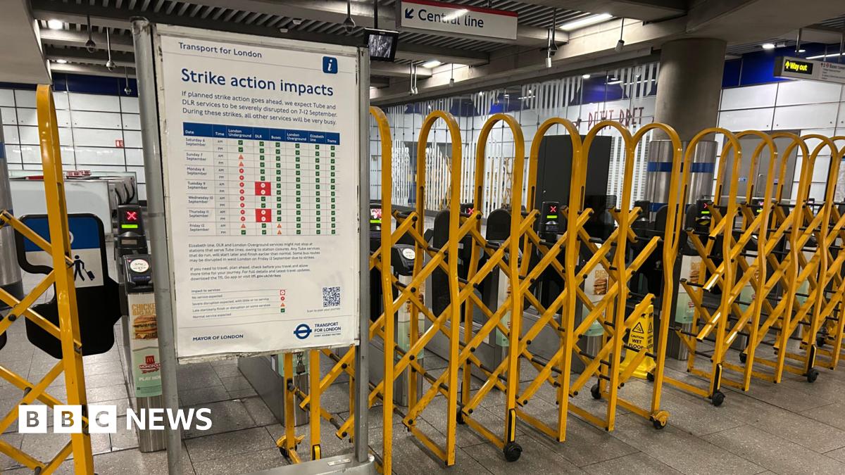 Yellow metal gates pulled across barriers near a 'strike action impacts' sign