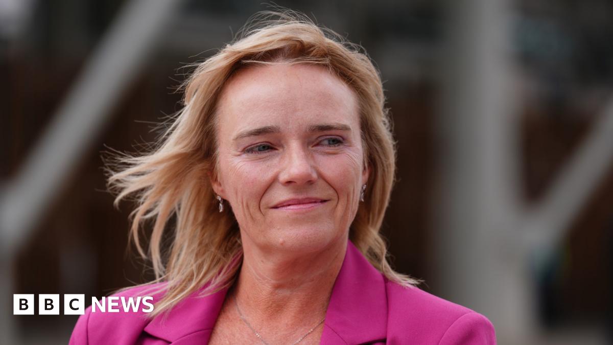Sandie Peggie, with shoulder length fair hair, wearing a pink jacket