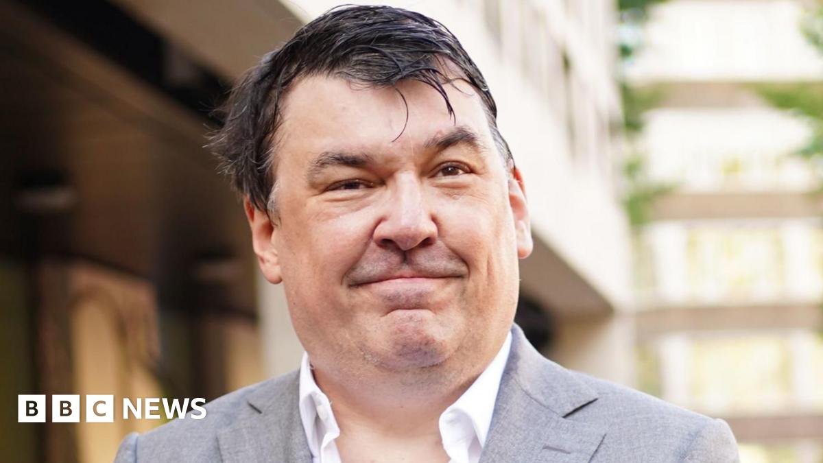 Graham Linehan smiling in a grey jacket