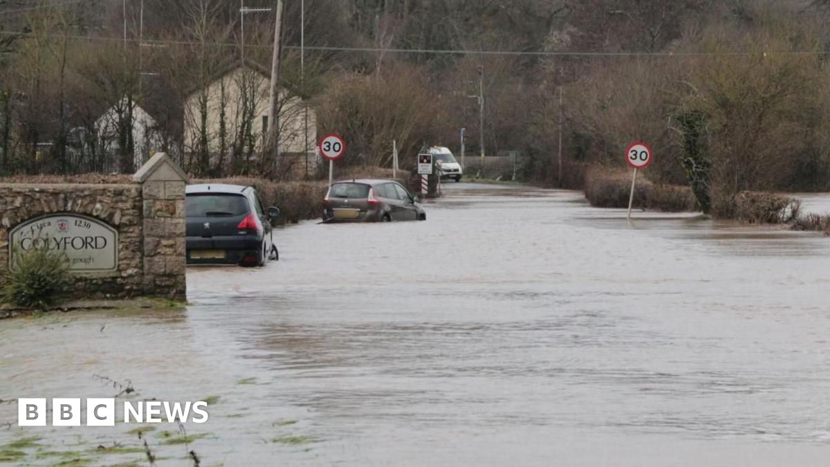 Cars half submerged in water on a road in the south west.