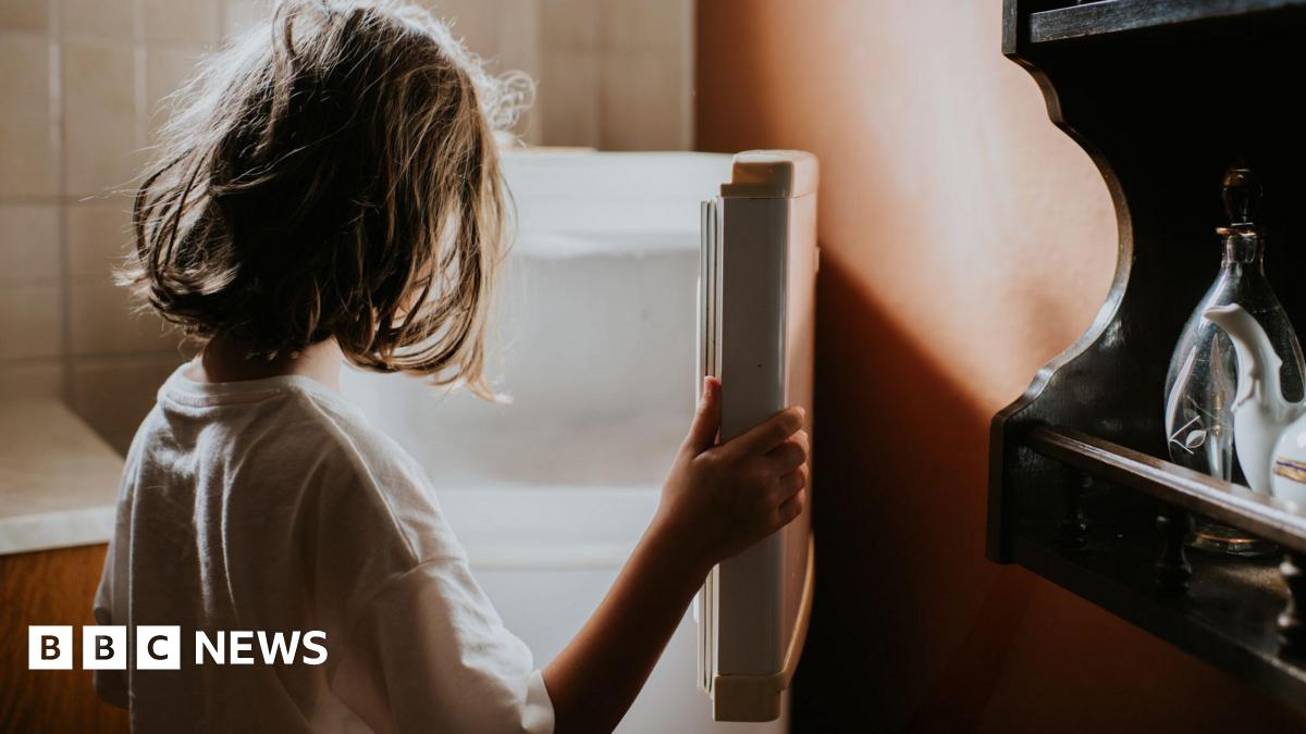 Child looks into empty fridge
