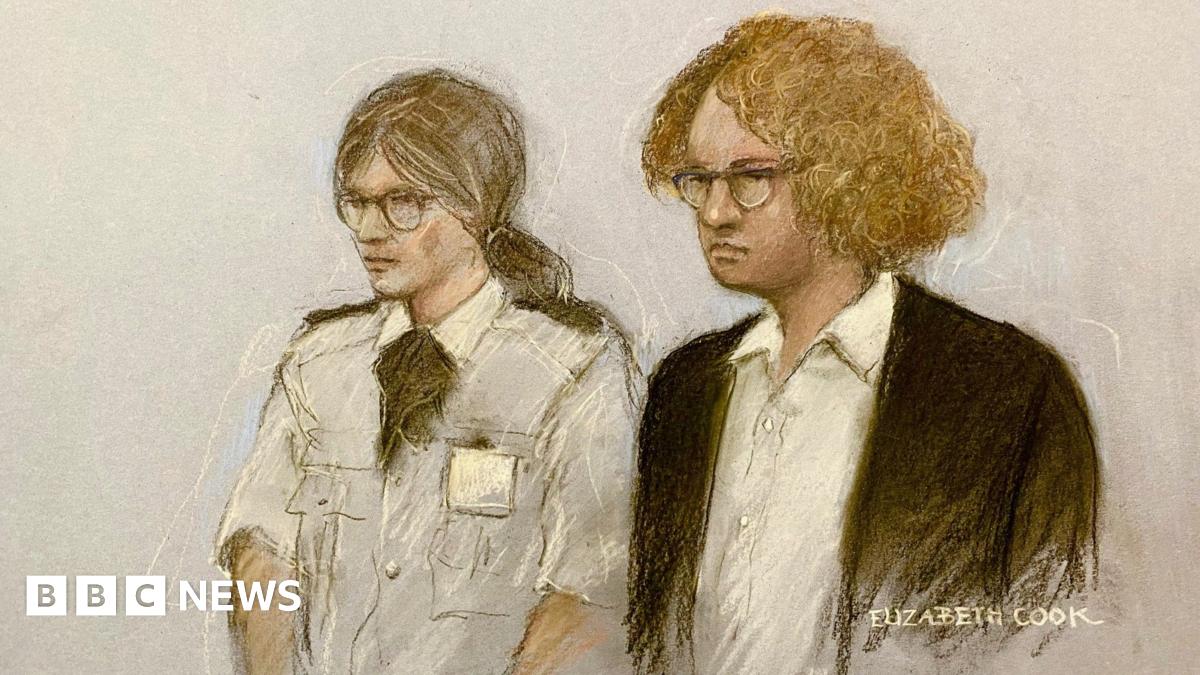 A sketch shows Gwyn Samuels standing in the dock, wearing a dark coloured jacket and a white shirt, with curly ginger hair and glasses. Next to her is a female security guard with tied-back hair and glasses.