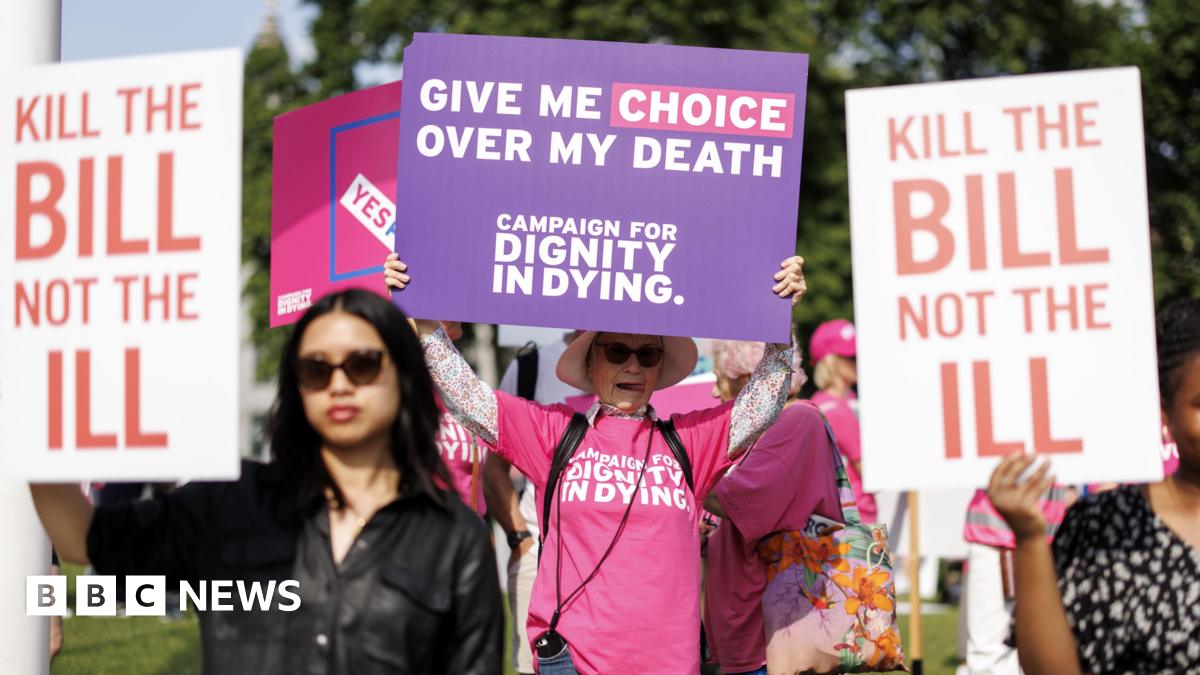 Campaigners and demonstrators in favour and against the assisted dying bill hold placards as they gather in Parliament Square in London