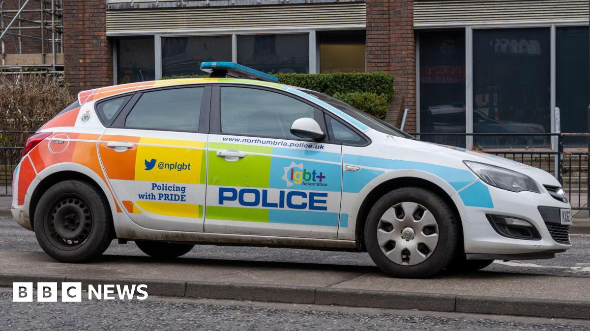 A Northumbria Police car parked in the city centre. It has been decorated in Pride colours and has the words Policing with Pride displayed on its door.