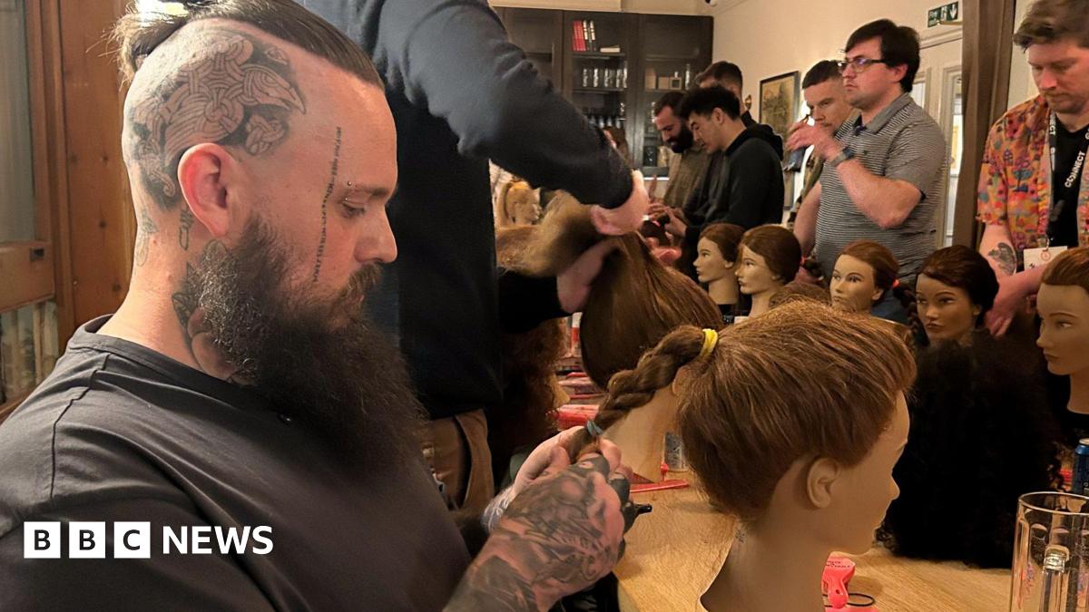 Tattooed father of two Paul Jessop gets to grips with a plait on his mannequins head.  