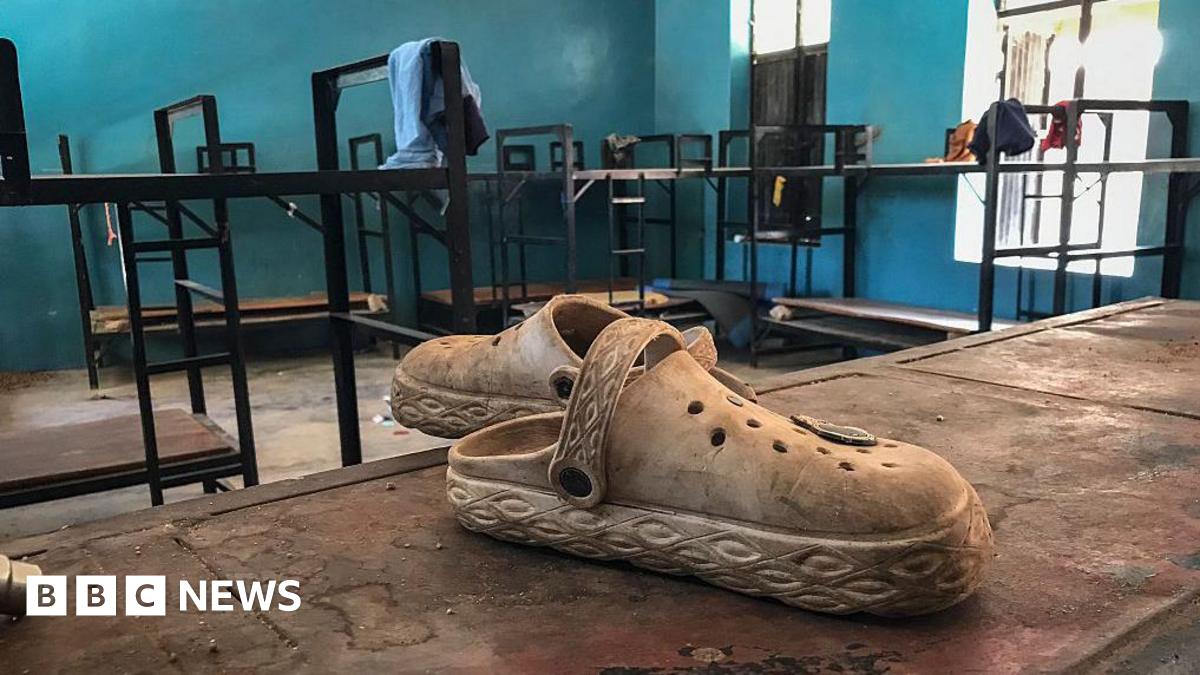 Shoes lie abandoned on a bunk bed in a school dormitory. 
