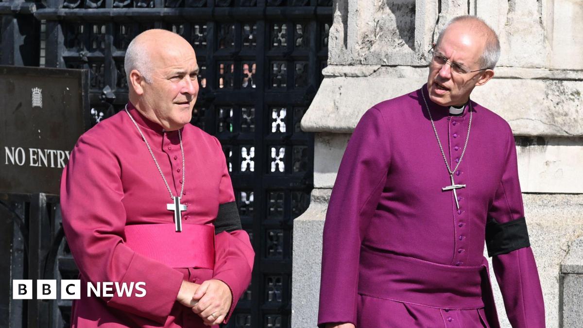 Archbishop of York Stephen Geoffrey Cottrell (left) and The Archbishop of Canterbury Justin Welby outside Westminster Hall, London. They are wearing robes and have a cross hanging around each of their necks.