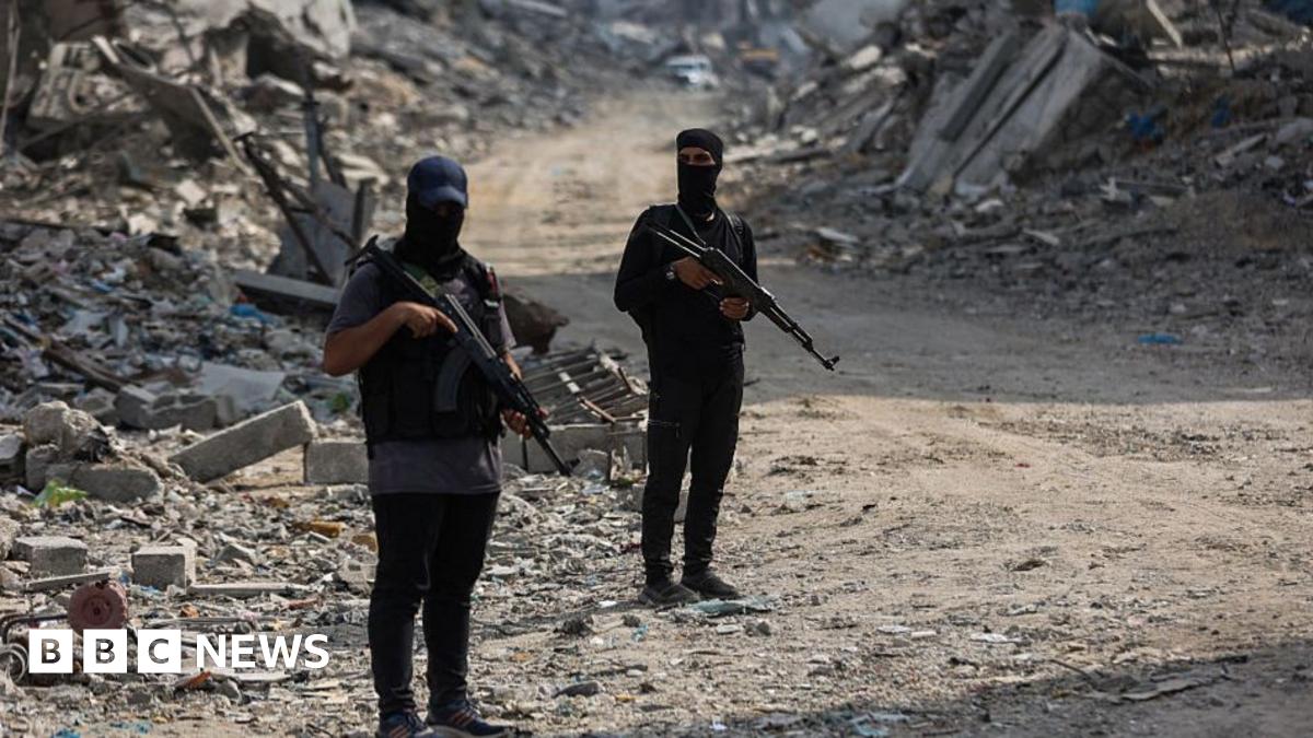 Hamas fighters guard an area of Gaza City where they are searching for the bodies of hostages with the help of the International Committee of the Red Cross (ICRC), in northern Gaza (3 November 2025)