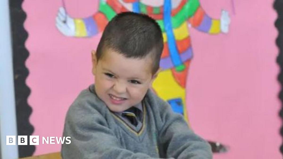 A young child in a school uniform