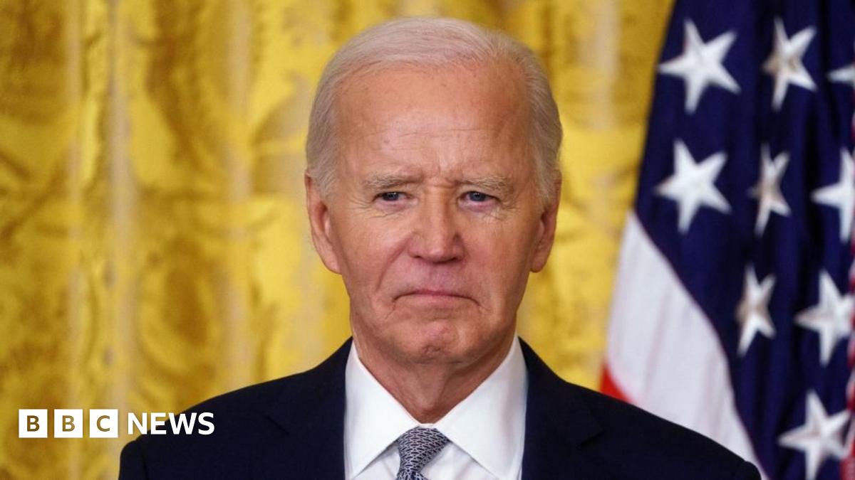 Joe Biden standing in front of a US flag