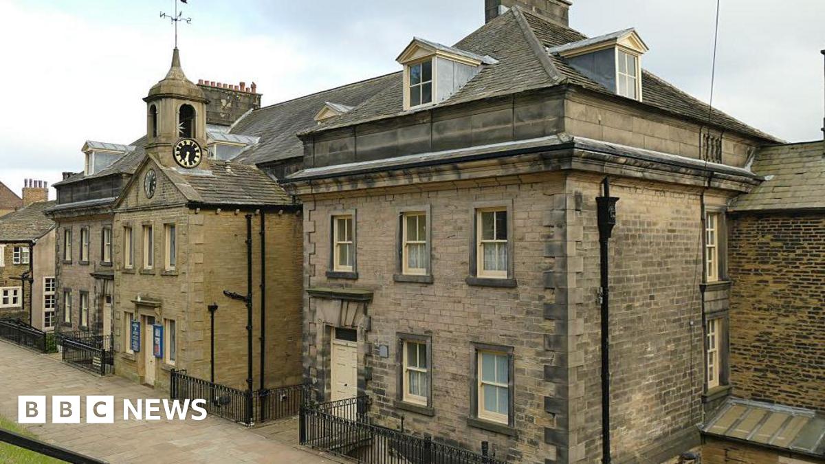 A large brick building with cream painted windows on the school estate.