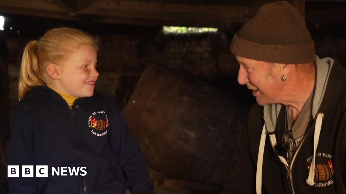 Jessica, aged 7, and Les White, aged 69, at the Ottery St Mary tar barrels event