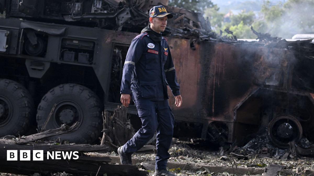 A firefighters passes by a burnt military vehicle at La Carlota air base in Caracas on January 3, 2026, after US forces captured Venezuelan leader Nicolas Maduro after launching a "large scale strike" on the South American country. 