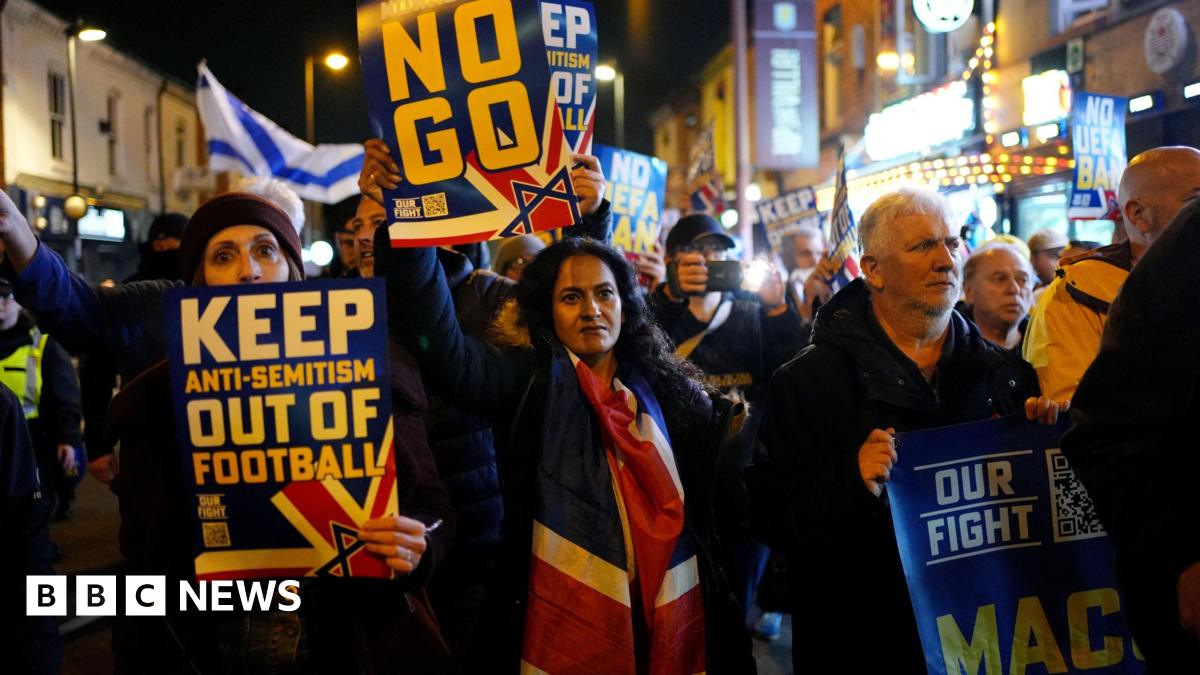 Pro Israel supporters are led to Villa Park, home of Aston Villa by police officers, before the UEFA Europa League match at Villa Park, Birmingham