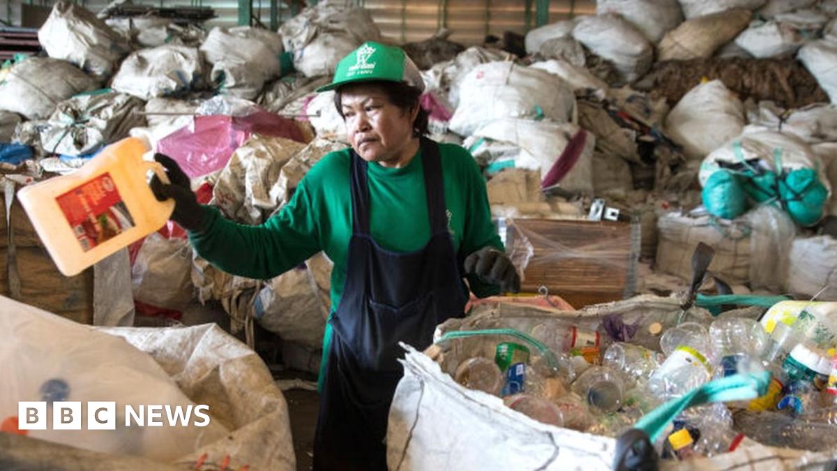 A worker in Thailand separating plastic bottles