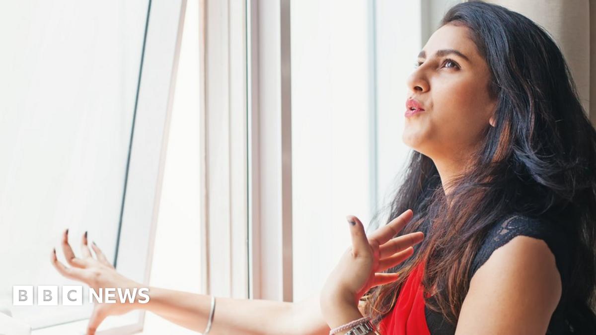 Woman opening window due to extreme heat