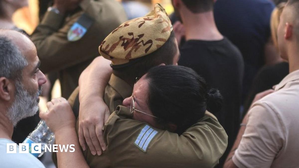 Two Israelis hug