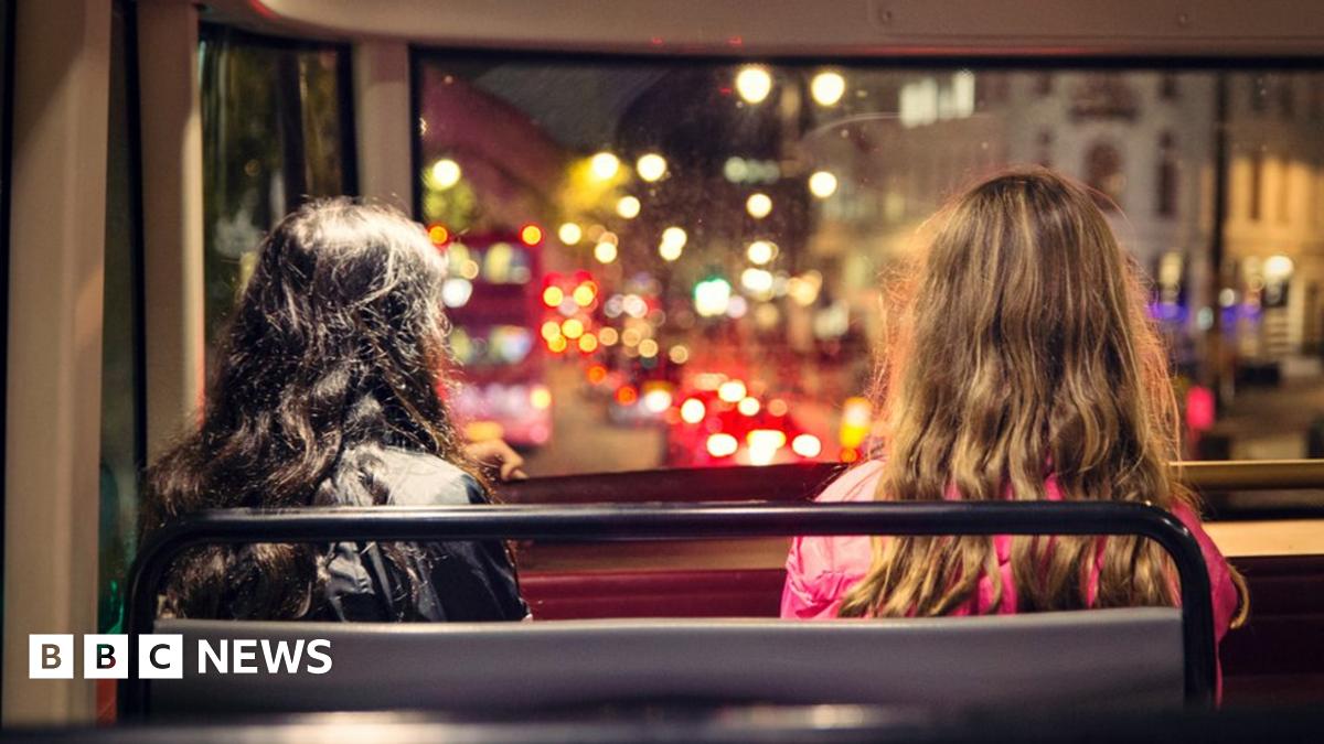Two people sitting on London bus