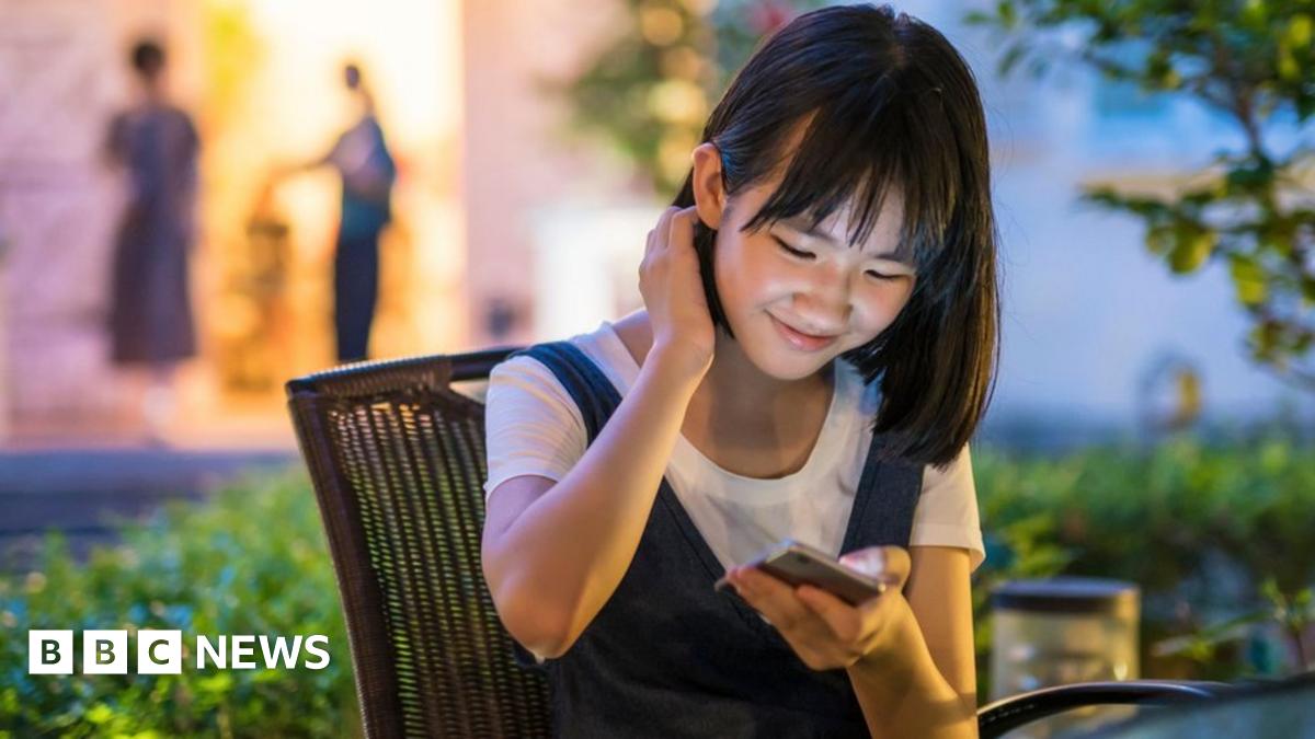 Chinese teenager uses phone