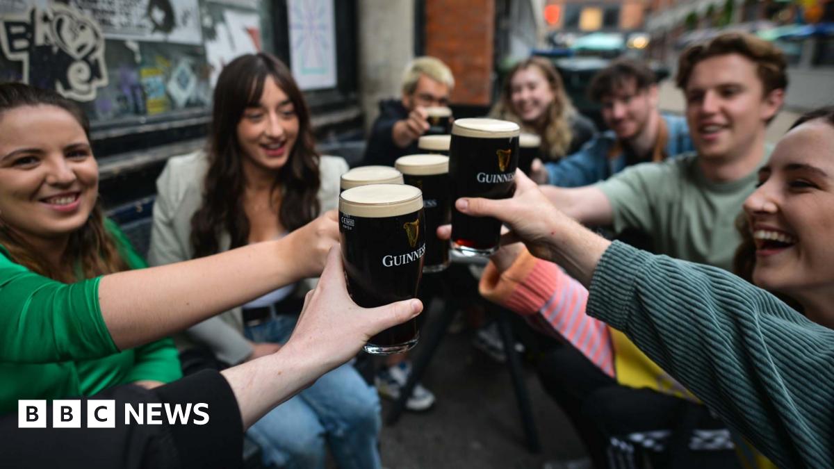 People enjoy drinking Guinness outside a pub in Dublin, Ireland