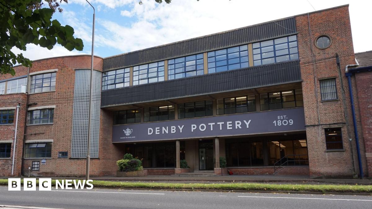 Exterior of Denby Pottery firm. Brick building with sign reading 'Denby Pottery'