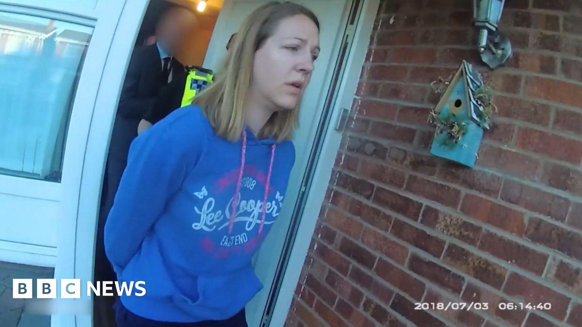 Police body-cam footage of Lucy Letby, with straight blonde hair and wearing a blue hoody, being led from her front door