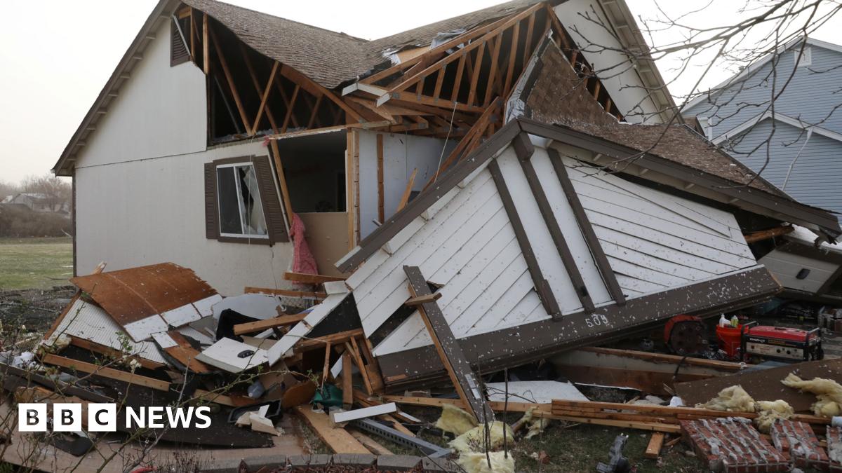 Debris piled around a downed home in Florissant, Missouri on 15 March