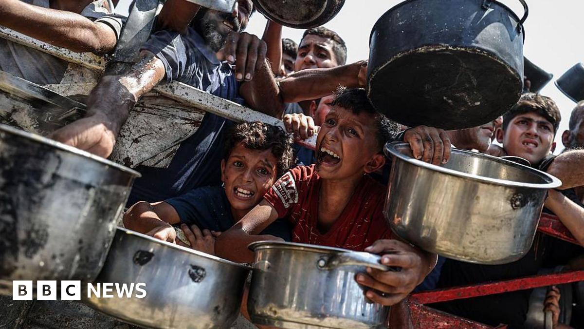 Palestinians wait for food at a charity kitchen in Gaza City, northern Gaza (28 July 2025)