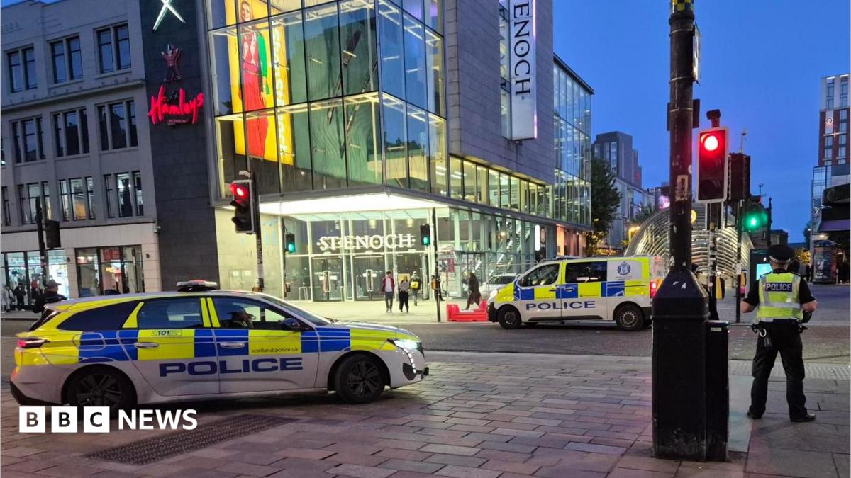 Police vehicles and officers outside the St Enoch Centre in Glasgow at night