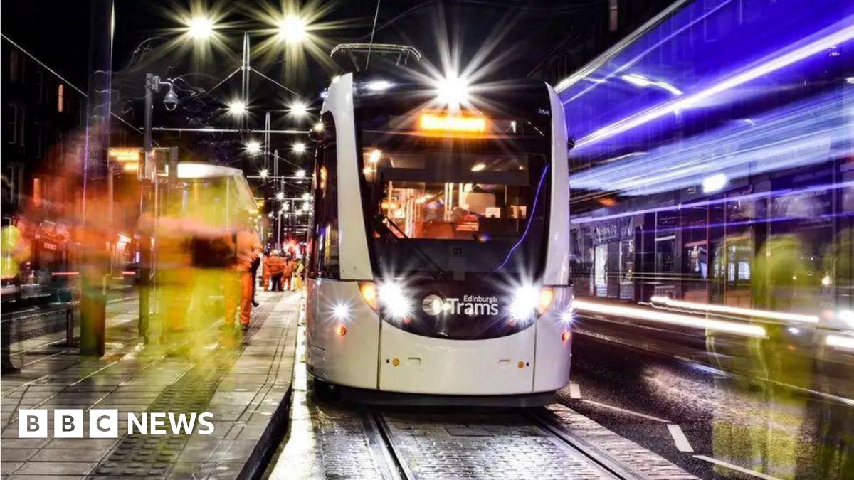 Bright lights of a tram at a tram stop.